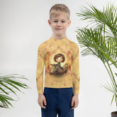 Child wearing CB6-19 Rash Guard at the beach - Demonstrating the guard's sun protection in action.